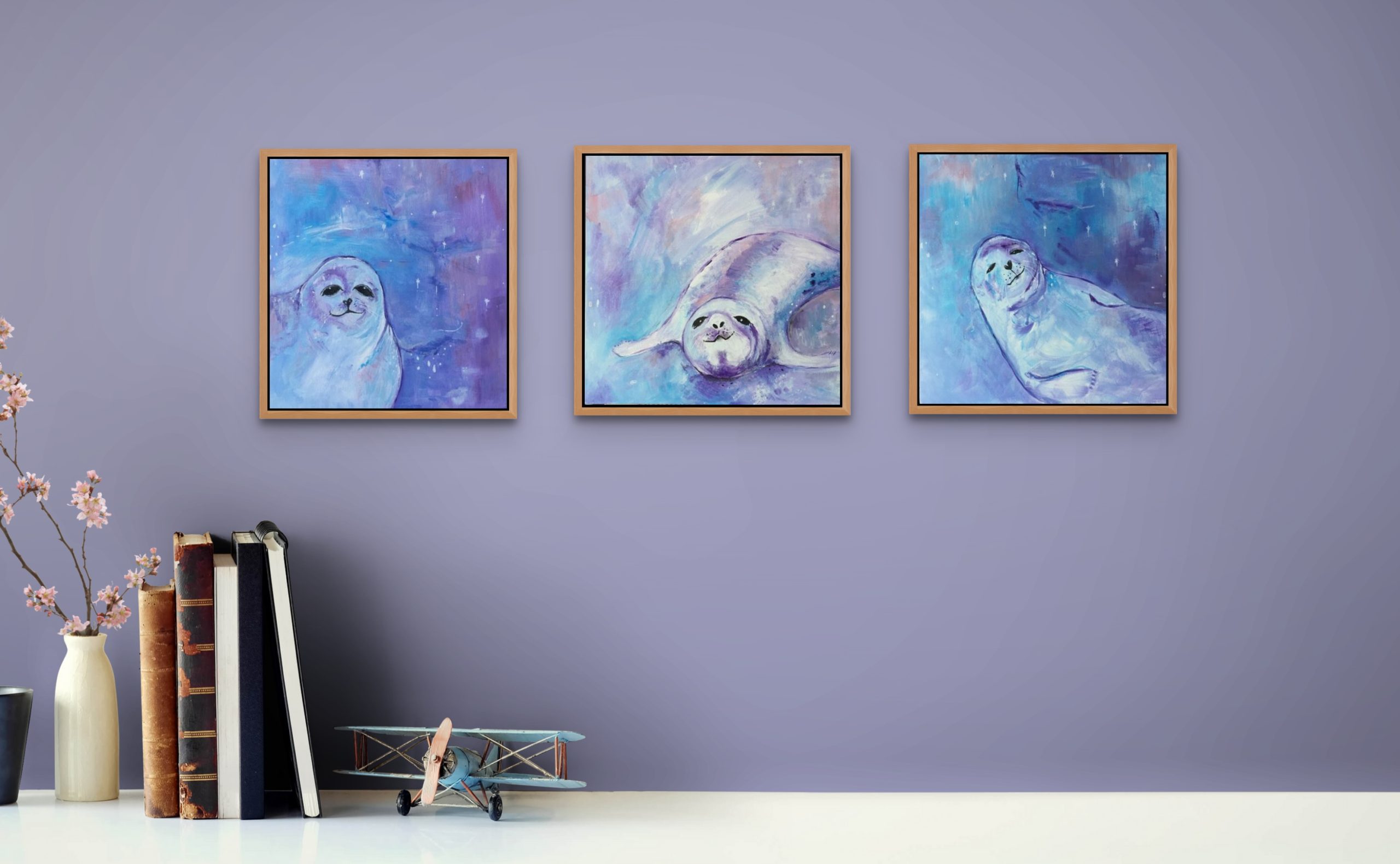 A set of 3 seal paintings to delight you and bring joy and magic to your walls. All 3 show cheeky seals painted in tones of white, pale blue and lilacs against star studded skies of the same tones of colour.