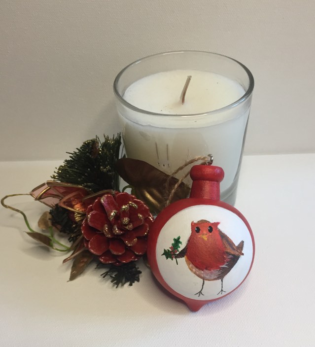 Special Christmas Bauble painted by hand and featuring a red breasted robin in a white circle holding a sprig of holly.