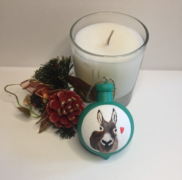 Special Christmas Bauble painted by hand and featuring a delightful donkey in the white circle and red heart beside her.