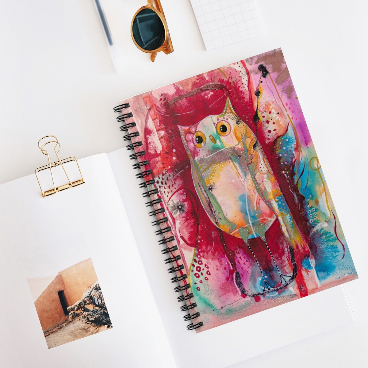 Whimsical owl journal in context- Owl is multi-coloured on an abstract background.