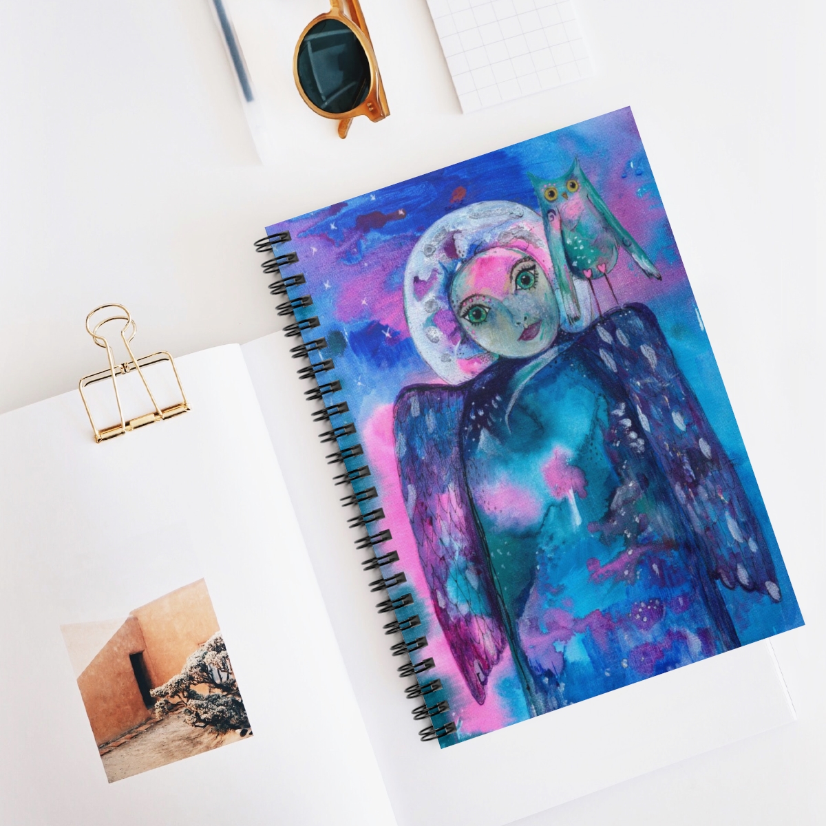 Angel journal in context. It takes the image - guardian angel of Intuition - she is created from abstract blues and pinks. Her moon like face is surrounded by a silver halo and she has an owl on her shoulder.