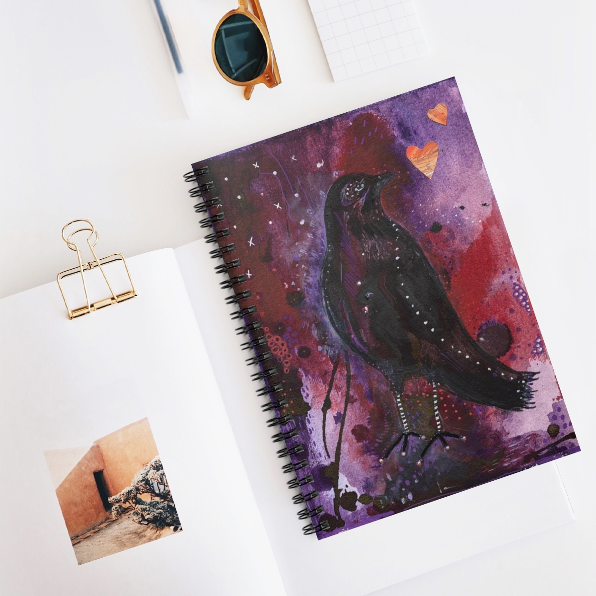 Special journal in context- crow design on an abstract background of purple tomes.