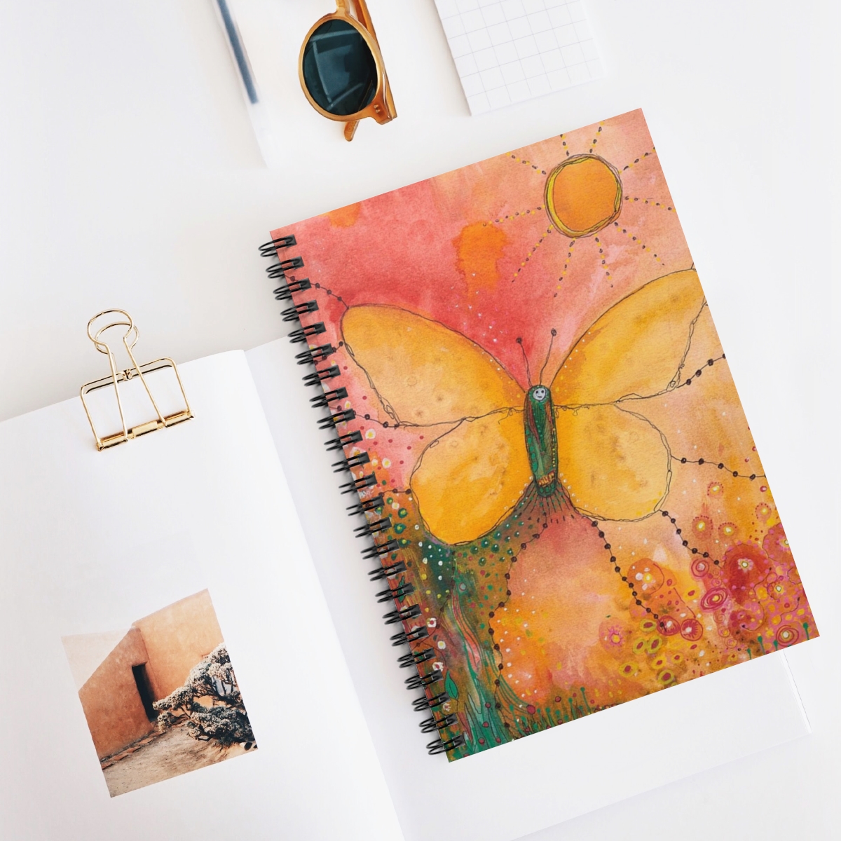 Butter fly journal in context. Image of butterfly uses soft tones of yellows and oranges and the butterfly is rising to greet the sun