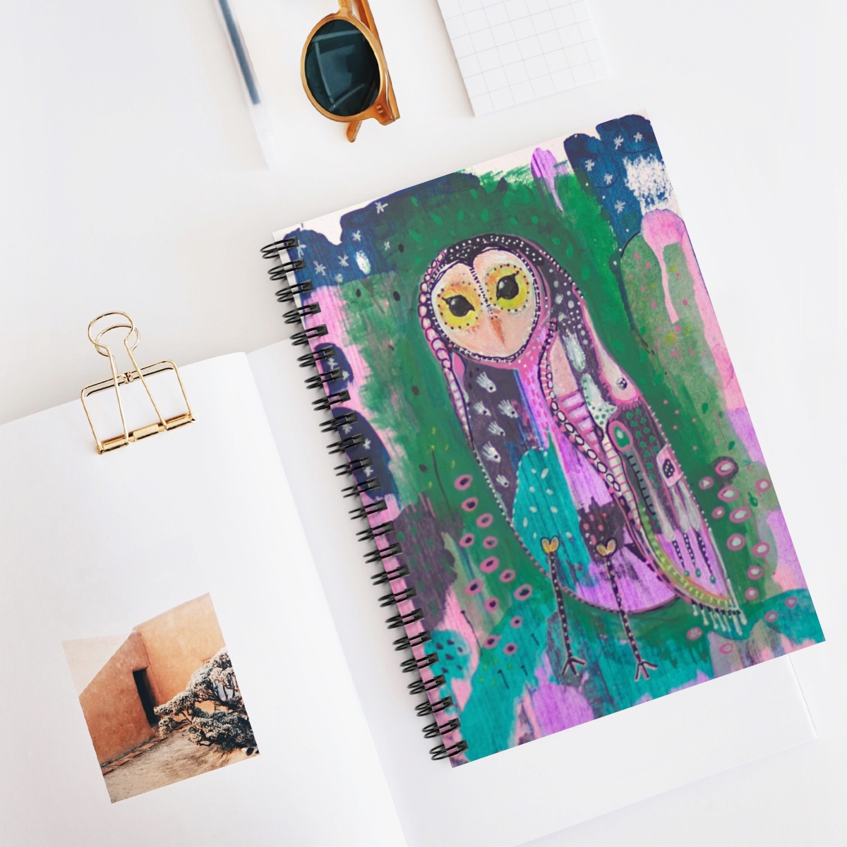 Beautiful Owl journal in context - Owl Spirit guide is a colourful patchwork, whimsical owl based on the barn owl. She stands against an abstract background of green, pink and blue.