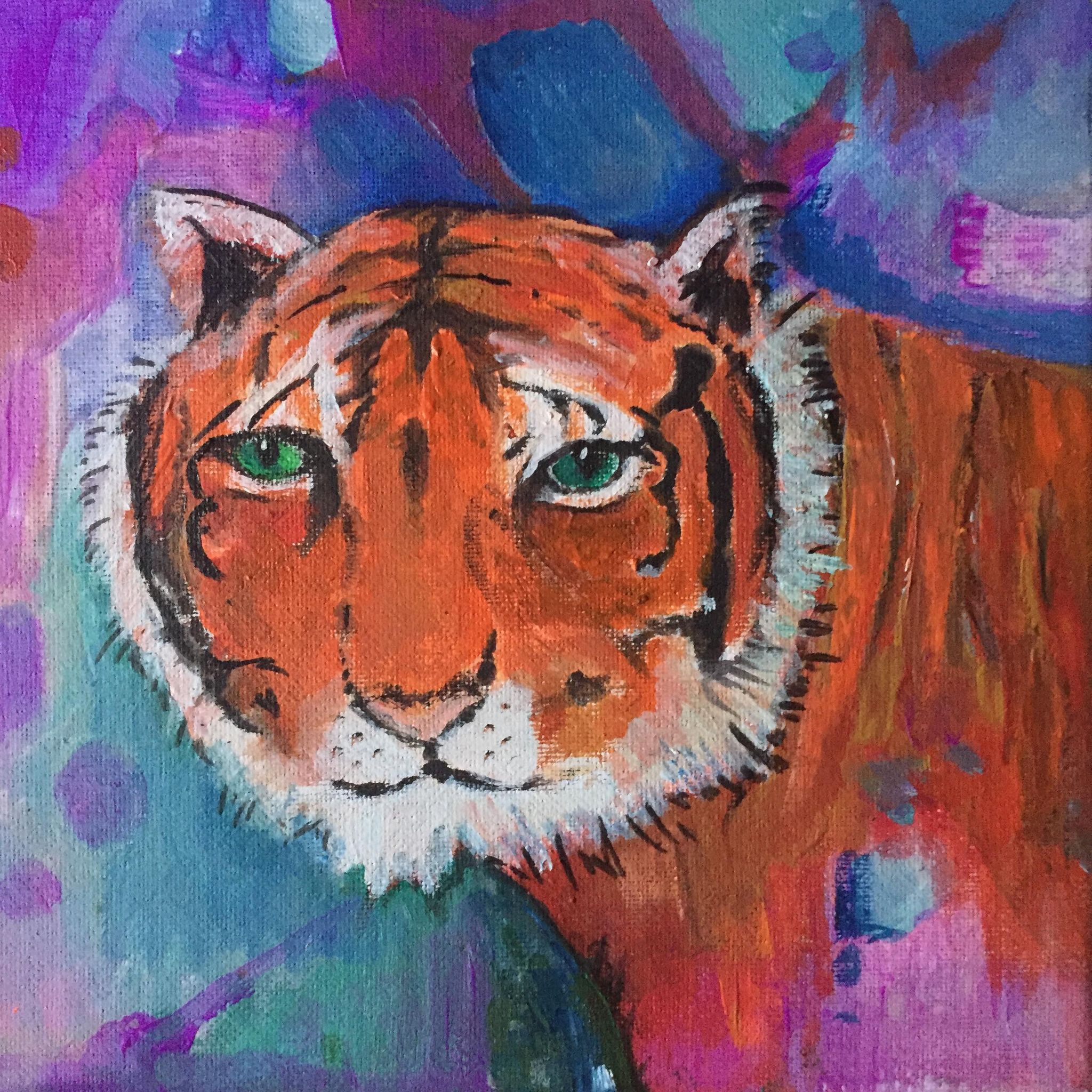 Tiger painting. Tiger face painted as if emerging from an abstract background of purples and blues. Part of his body can be seen from the right of the painting.