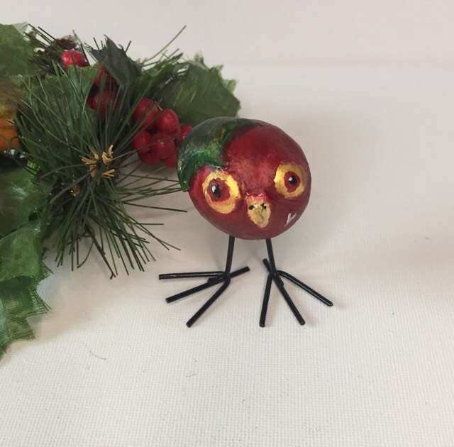 Collectible Christmas Owling. Holly berry is a rich red owl sculpture made from clay. She has a holly leaf for hair and long wire legs with oversized feet.