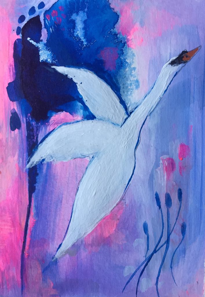 This magical swan art shows the swan gliding into the sky, wings graceful and elegant. Her background is an abstract blend of pink, lavender and blue. A small crop of bulrushes wave in the breeze below her.
