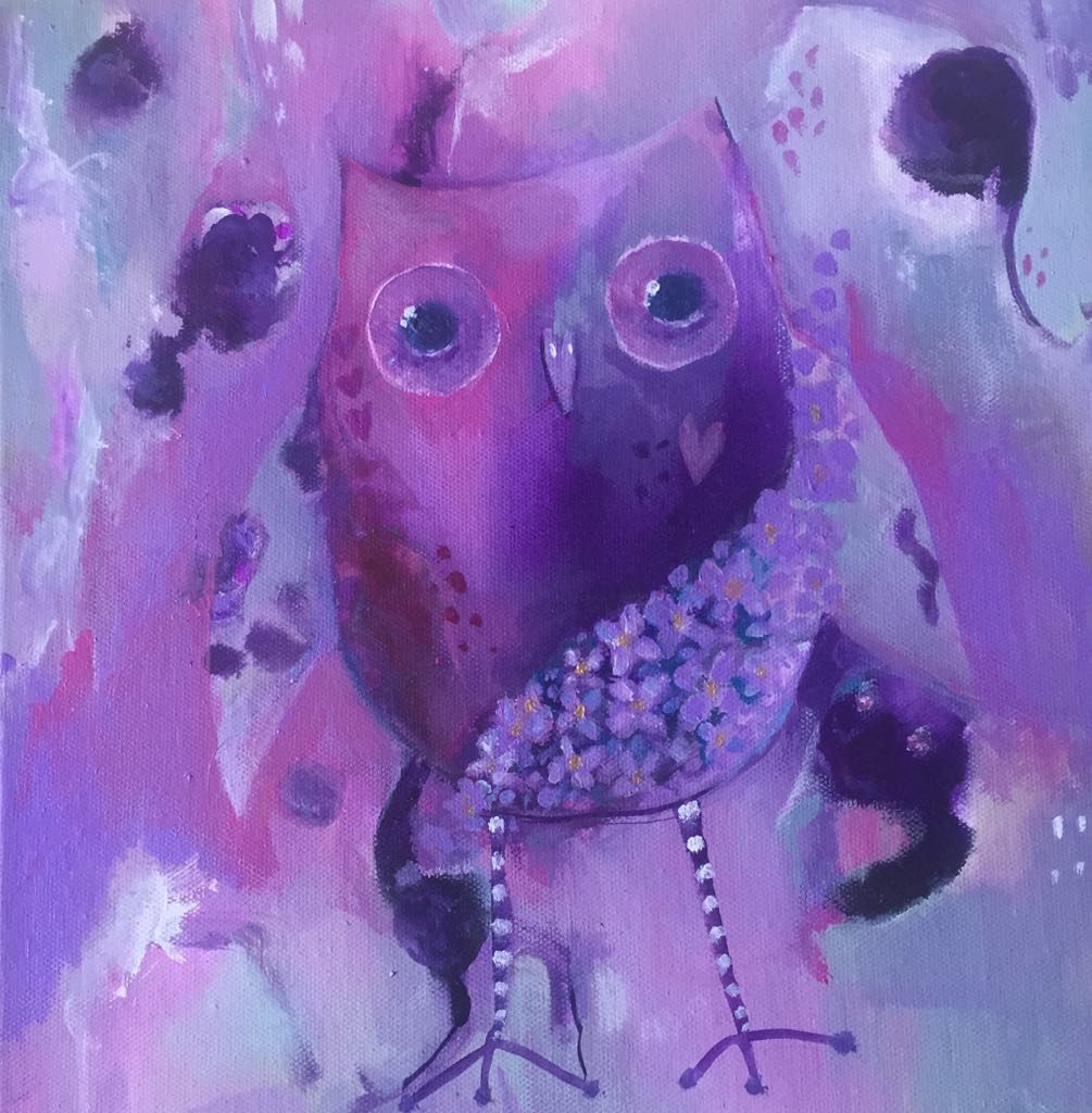 This magical owl is painted in purples and pinks and light greens. She stands on a background of similar hues and lilac flowers swirl across her body.